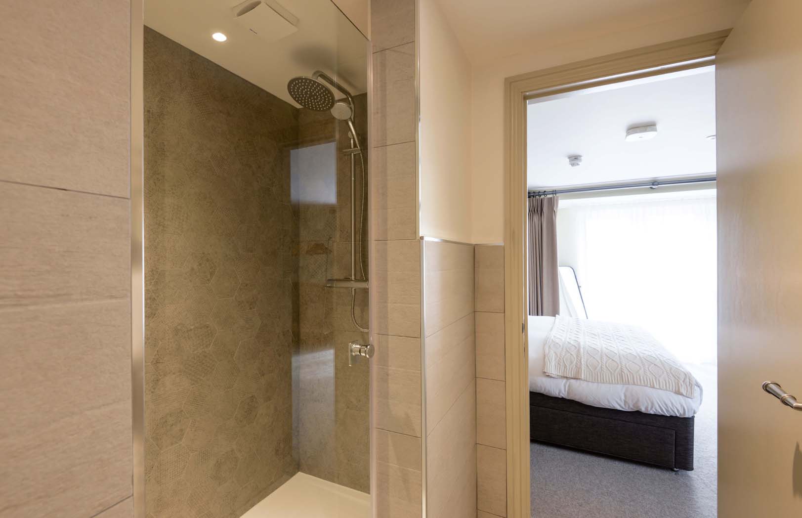 Chew - Bright bathroom with spotlight lighting, and tiled walk-in shower