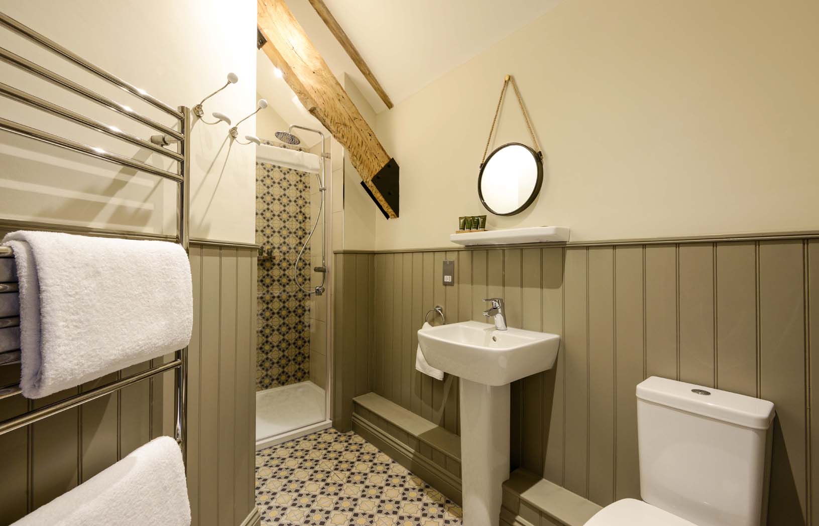 Chewton Head - Bathroom with decorative wooden panels, geometric tiles, walk in shower and heated towel rack