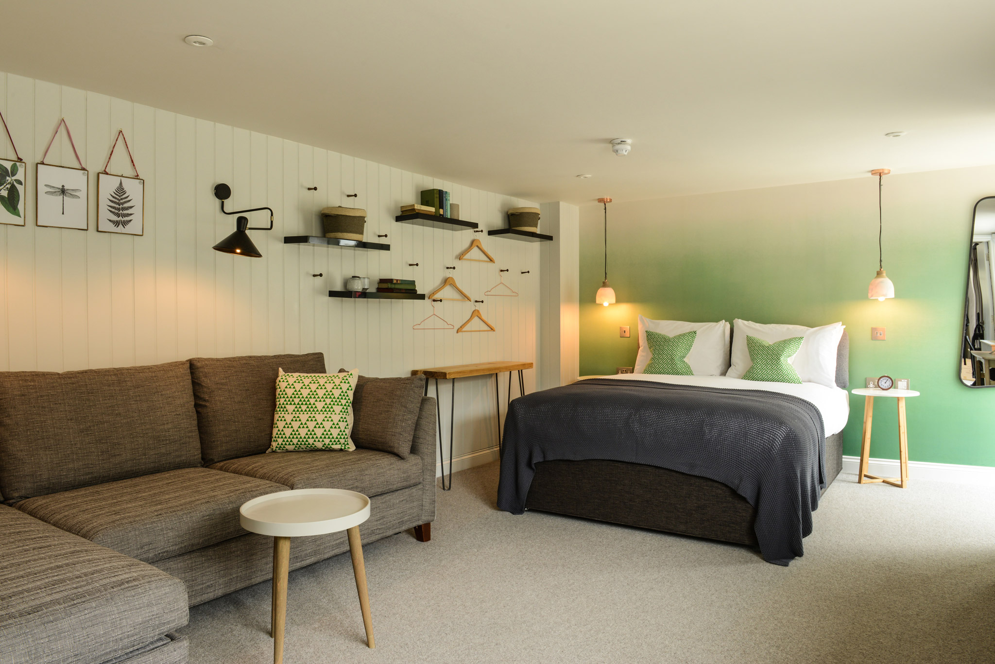 Stay in Oatfields, a kingsize room at The Litton. Green blended wallpaper with quirky art on the walls.