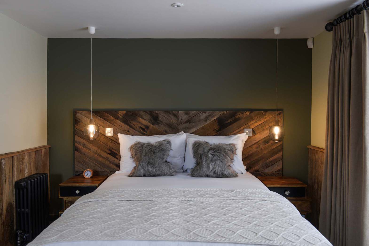 Chew - King sized bed with white linen, Wooden features, ambient lighting and fluffy pillows