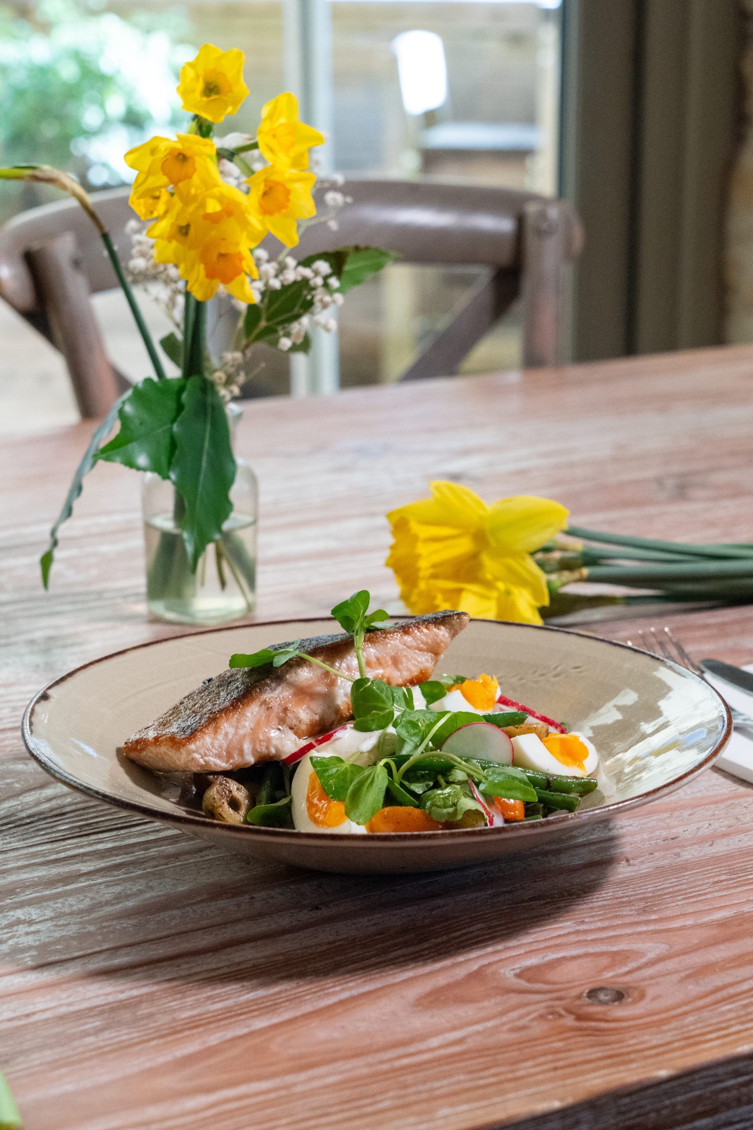 Warm salmon salad at The Litton pub in Somerset with pan fried salmon, new potatoes, green beans, soft egg and lemon crème fraîche